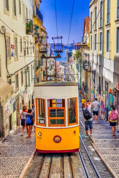 people walking on street near yellow tram